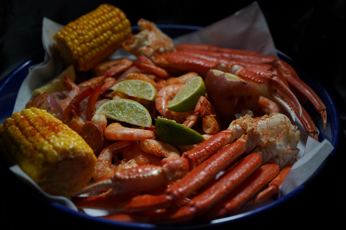 Shrimp, crab, and corn on a blue plate