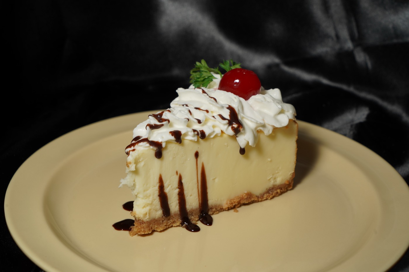 Cheesecake with whipped cream and a cherry