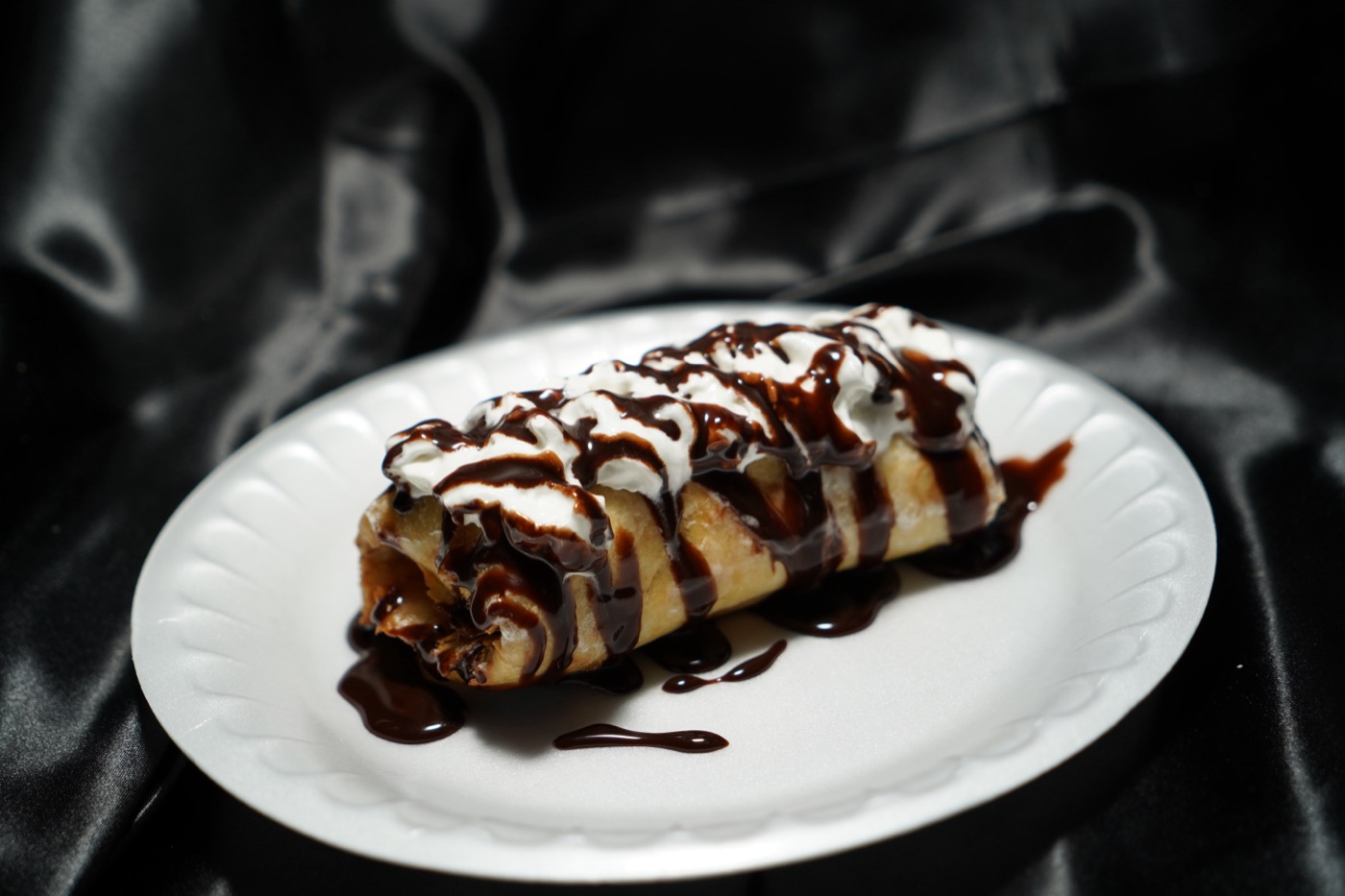 Churro with whipped cream and chocolate